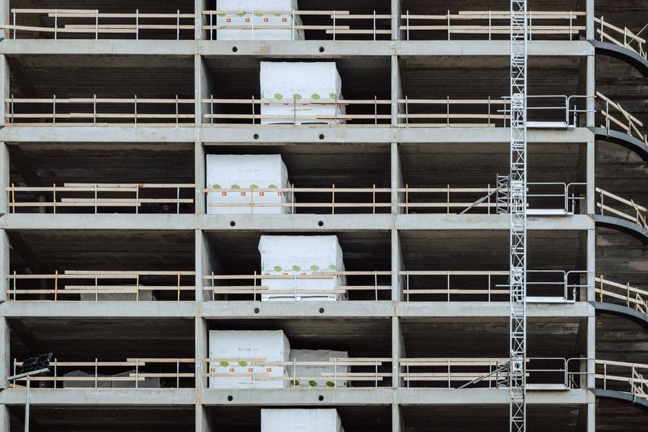 Close-up of a multi-storey building under construction, showcasing steel and concrete structure.