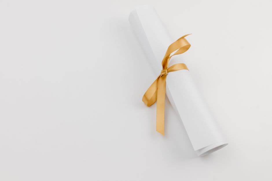 Rolled paper tied with a gold ribbon symbolizing achievements and celebrations.